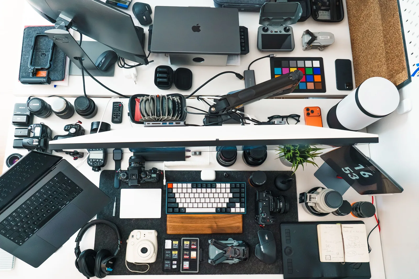 Top view of a well-organized photography and editing workspace with various equipment. UGC creator quote framework: scope, rights and workflow