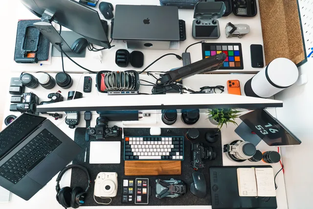 Top view of a well-organized photography and editing workspace with various equipment. UGC creator quote framework: scope, rights and workflow