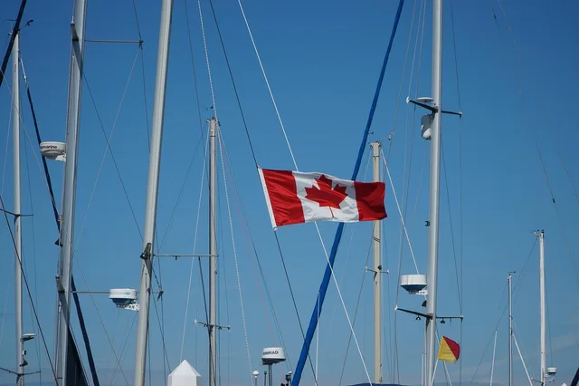 canada flag, blue, sky, wind, symbol, canadian, red, white, travel, boat, nature, flags, banner, blue sky, outdoors, blue banner. UGC creator usage rights Canada: what a licence should say